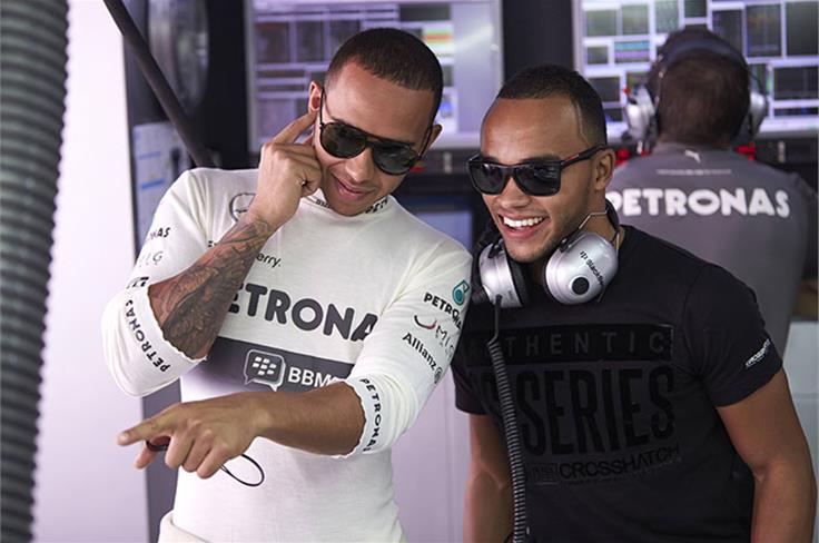 Lewis Hamilton shows his brother Nicolas Hamilton around the Mercedes F1 garage.